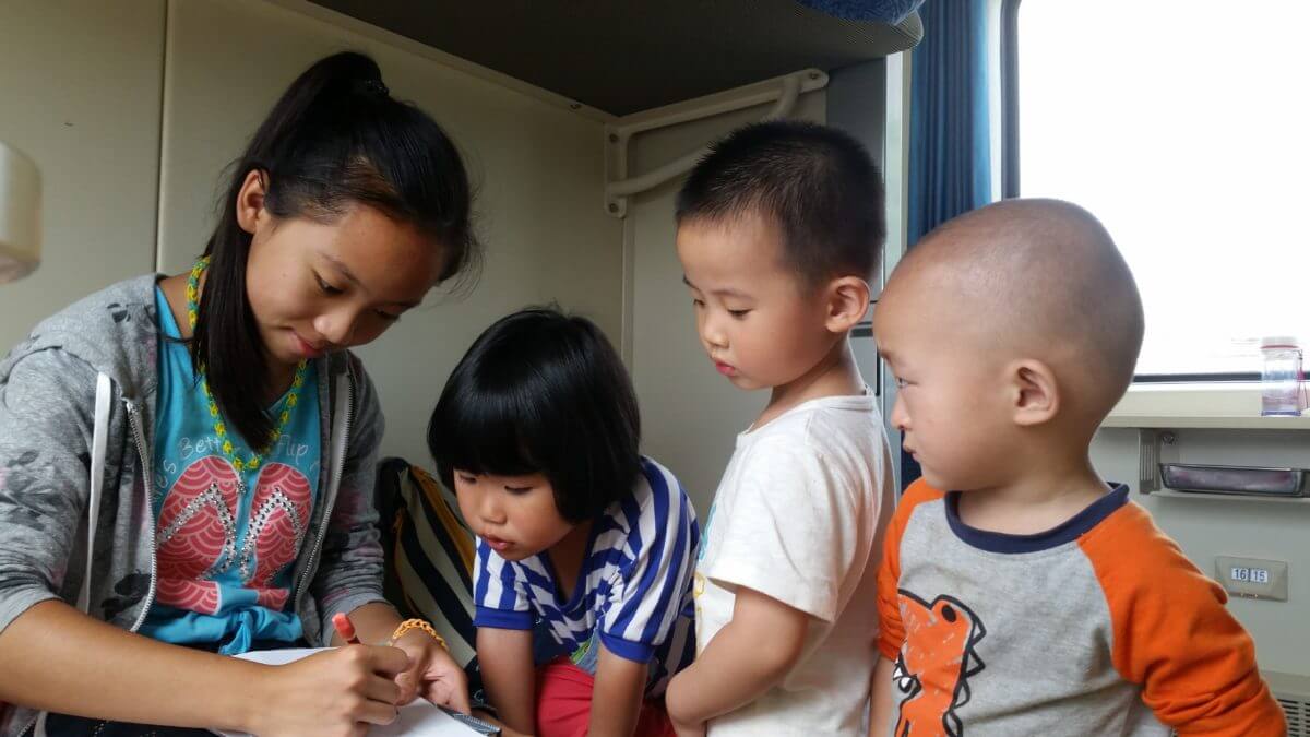 Welcome Aboard author with three small children drawing