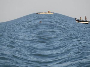 A photograph of the ocean with a fish-eye filter.