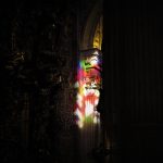 A photograph of a carved column lit up at night.