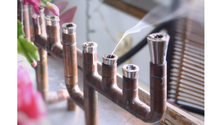 A photograph of smoke coming out of a menorah.