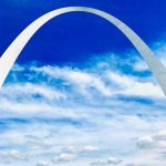 A photograph of an enormous arch in the sky.