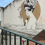 A photograph of a mural in a city street.