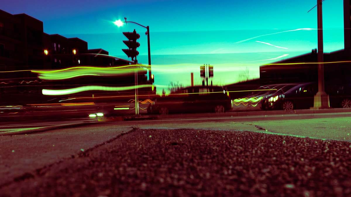A photograph of a city street at night with blurry lines of light.