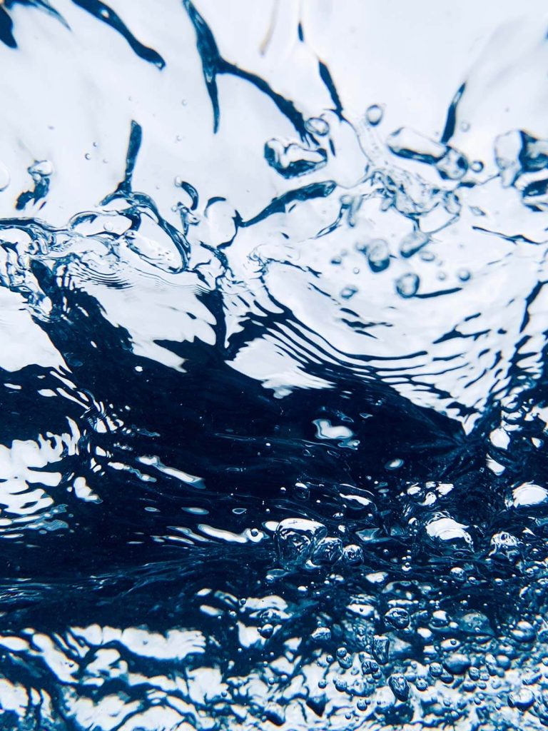 A photograph of water filled with bubbles.